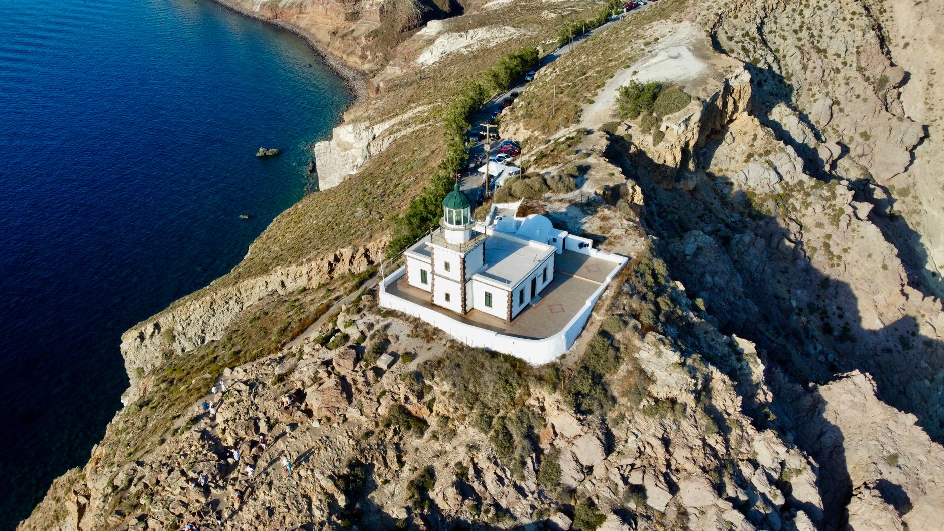 Discover the stunning Akrotiri Lighthouse perched on the rocky cliffs of Santorini, Greece.